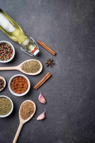 Mix of herbs and spices on dark stone table