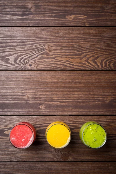 Freshly squeezed juices on wooden table