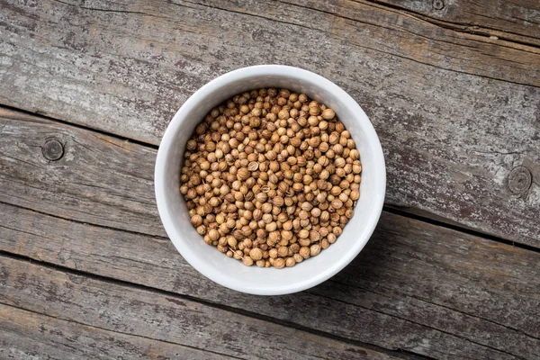 Dry coriander in white bowl — Stock Photo, Image