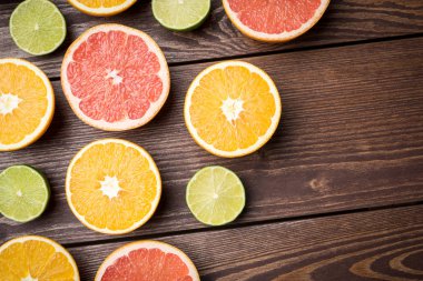 Ahşap masa üzerinde renkli narenciye yarım.