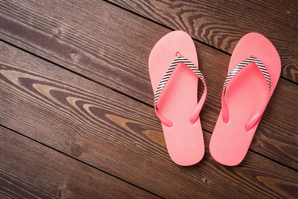 Flip flops on wooden table — Stock Photo, Image