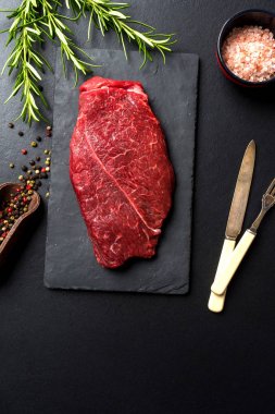 Raw beef steak with herbs and spices clipart