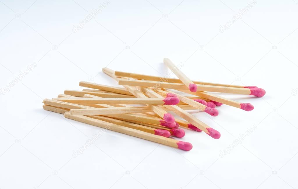 Pile of big matches with rose match head on white background