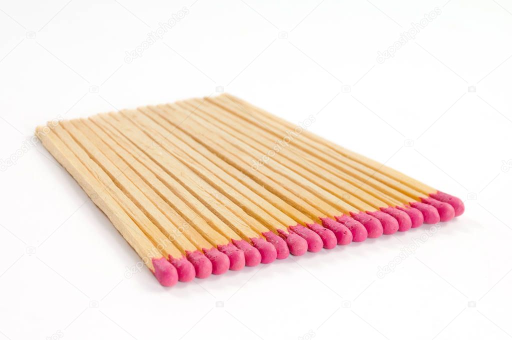 Row of several matches with rose match heads on white background