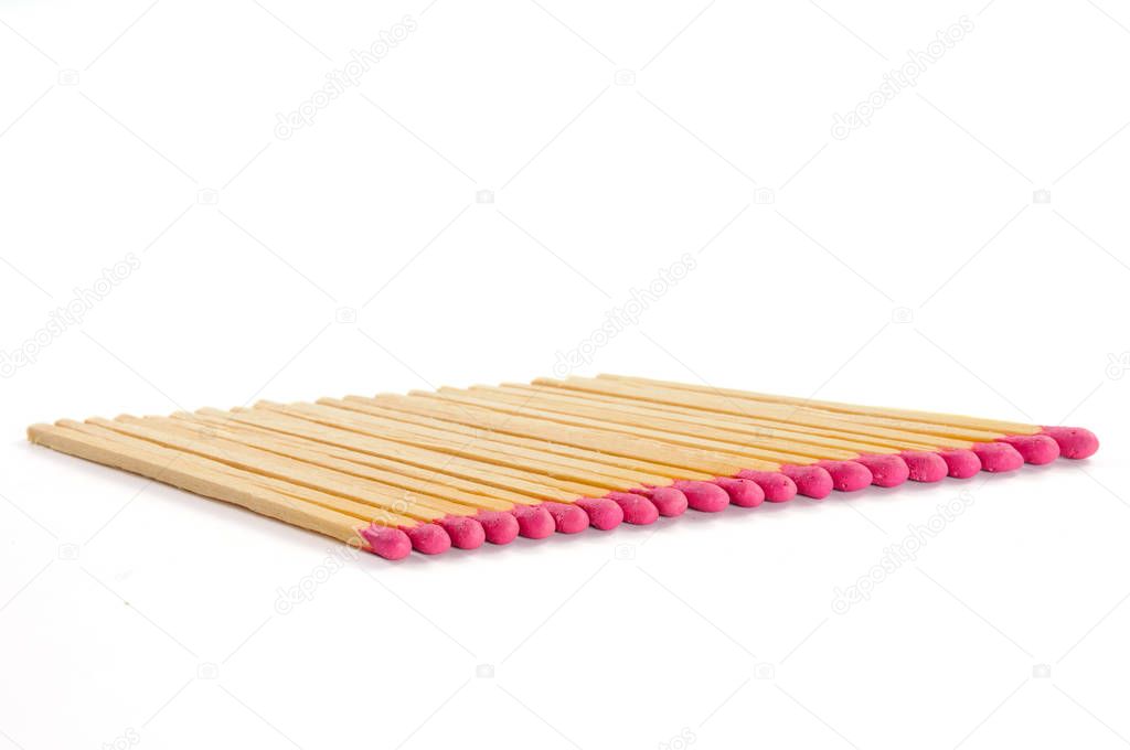 Row of twenty matches with rose match heads on white background