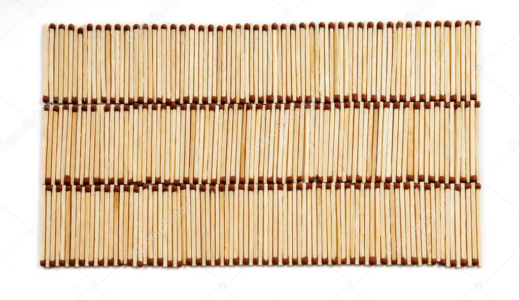 Three rows of many matches on white background view from above