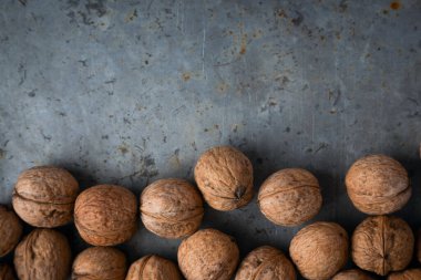 Gri arkaplandaki cevizler, metal yüzey, grunge, üstten, kopyalama alanı