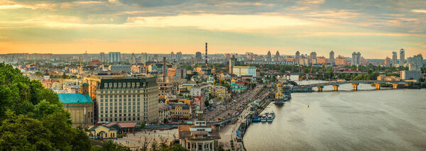 View to Podil district of Kyiv city from the Pedestrian Bridge at sunset.