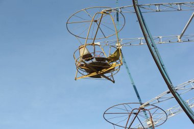 Dönme dolap mavi gökyüzünün karşı yuvarlak açık kabinleri  