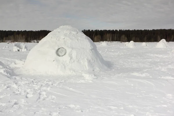 圆顶冰屋站在白雪皑皑的空地在冬天 — 图库照片