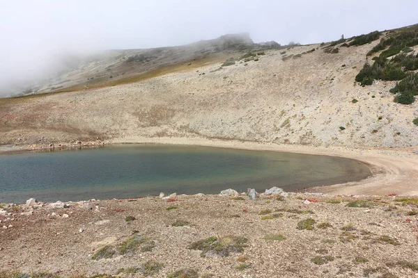 Lago congelado en la niebla de nubes cerca del Monte Rainier, EE.UU. — Foto de Stock