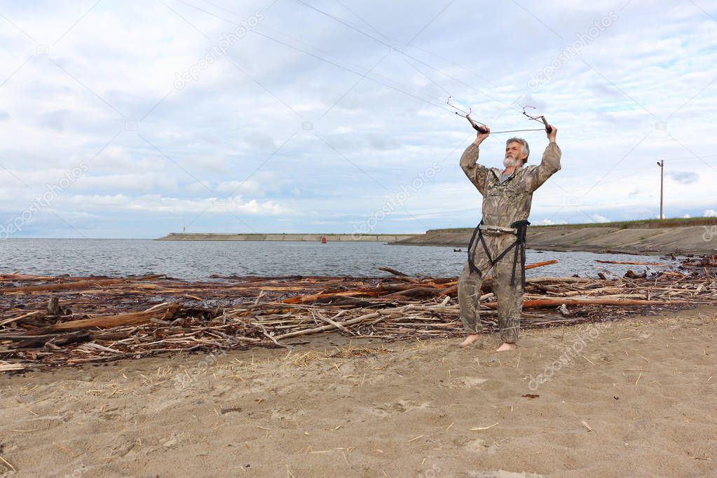 Man controls a kite in summer, Ob reservoir, Novosibirsk, Russia