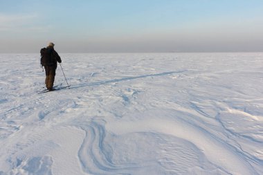 Donmuş nehirde kayak yapan adam