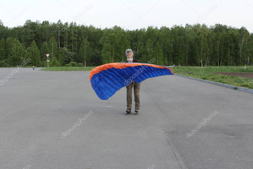Man training in roller skating with a kite, Novosibirsk, Russia