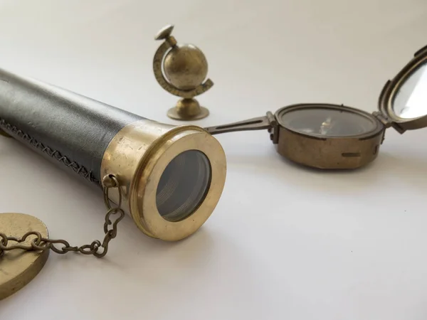 The compass and spyglass closeup on white background — Stock Photo, Image