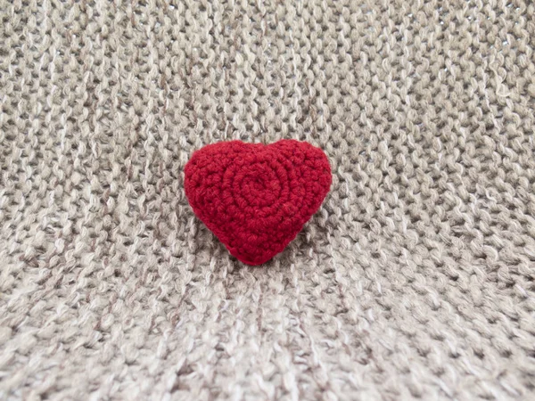 The warm background of the day of all lovers with knit hearts an
