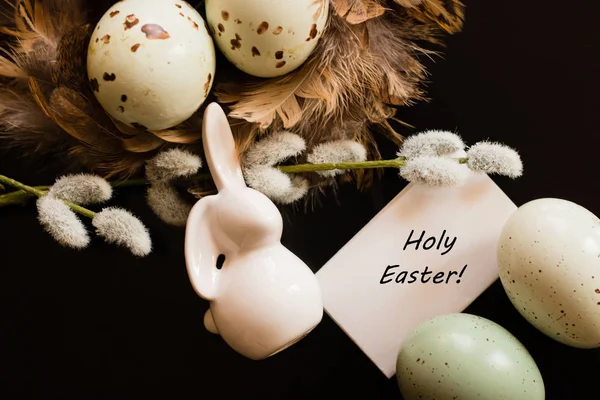 Small white rabbit figurine with easter eggs — Stock Photo, Image