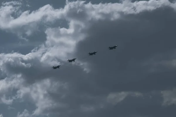 Four planes in the sky. Airshow on the day of the victory parade. An aerobatic group of four planes in a blue cloudy sky. | VERKHNYAYA PYSHMA, RUSSIA - 9 MAY 2020.