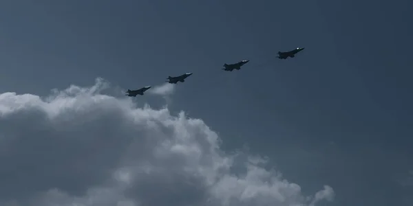 Four planes in the sky. Military fighters fly on the day of the victory parade. The Rus aerobatic team consists of four planes in a blue cloudy sky. | VERKHNYAYA PYSHMA, RUSSIA - 9 MAY 2020.