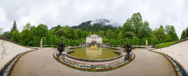 Ettal, Germany - June 5, 2016: Panorama of the Linderhof Palace. View of the main, south-north axis of the central complex. Fountain group Flora and puttos on the foreground.