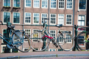 Amsterdam, Hollanda - 20 Nisan 2017: Amsterdam, Hollanda bir köprü üzerinde park etmiş Bisiklet