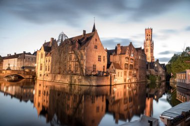 Bruges, Belgium - April 17, 2017: View from the Rozenhoedkaai of the Old Town of Bruges at dusk clipart