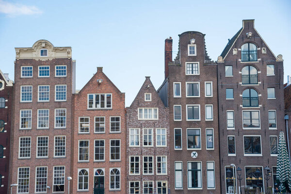 Traditional dutch buildings on canal in Amsterdam.