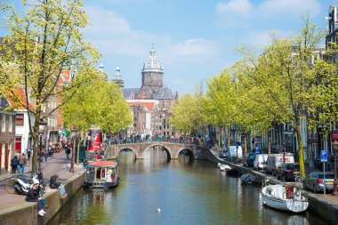 Amsterdam, Hollanda - 20 Nisan 2017: Amsterdam kanalları ve köprü, tekneler ve tipik Hollanda evleri ile harika manzara. Holland, Hollanda. Tabii ki turistler için güzel kez bakıldı.