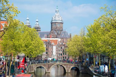 Amsterdam, Hollanda - 20 Nisan 2017: Köprü, kanal ve St. Nicolas Church Amsterdam'da. Amsterdam Hollanda'nın başkenti ve en kalabalık olduğunu