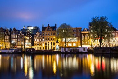 Amsterdam, Hollanda - 21 Nisan 2017: Gece boyunca Amsterdam kanalları ve setlerinin manzarası.