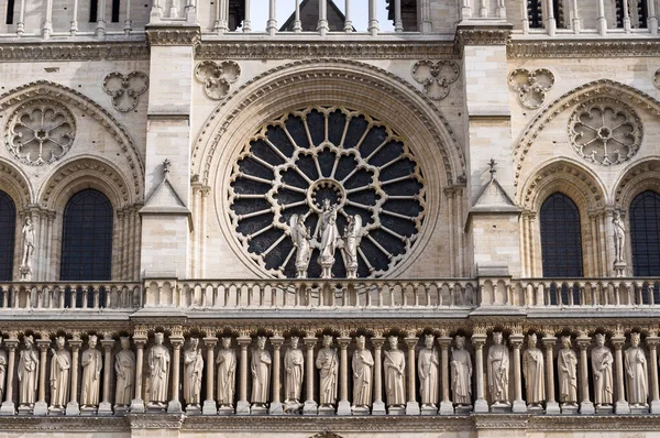 The western rose window, kings statues and architectural details of the catholic cathedral Notre-Dame de Paris. Built in French Gothic architecture, and it is among the largest and most famous church.