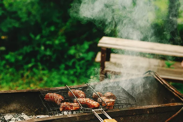 Grilled sausages roasting on grates — Stock Photo, Image