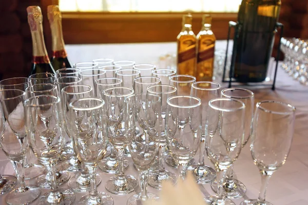 Stylish glasses at alcohol bar table — Stock Photo, Image