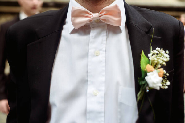 luxury stylish groom with boutonniere