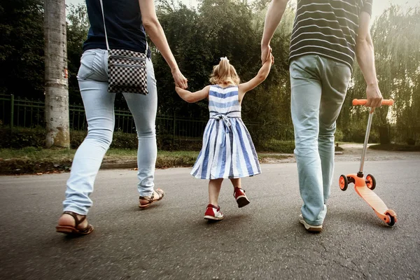 Родители держатся за руки с дочерью — стоковое фото
