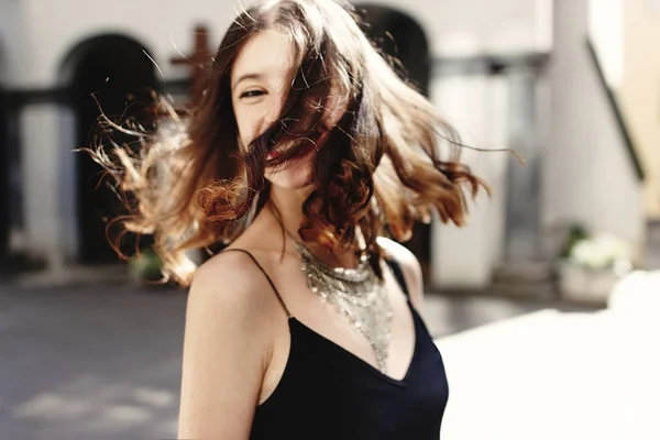 Happy stylish woman waving hair — Stock Photo, Image