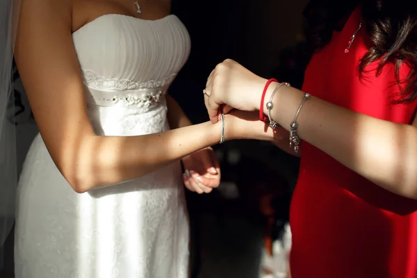 Bruidsmeisjes helpen krijgen armband — Stockfoto