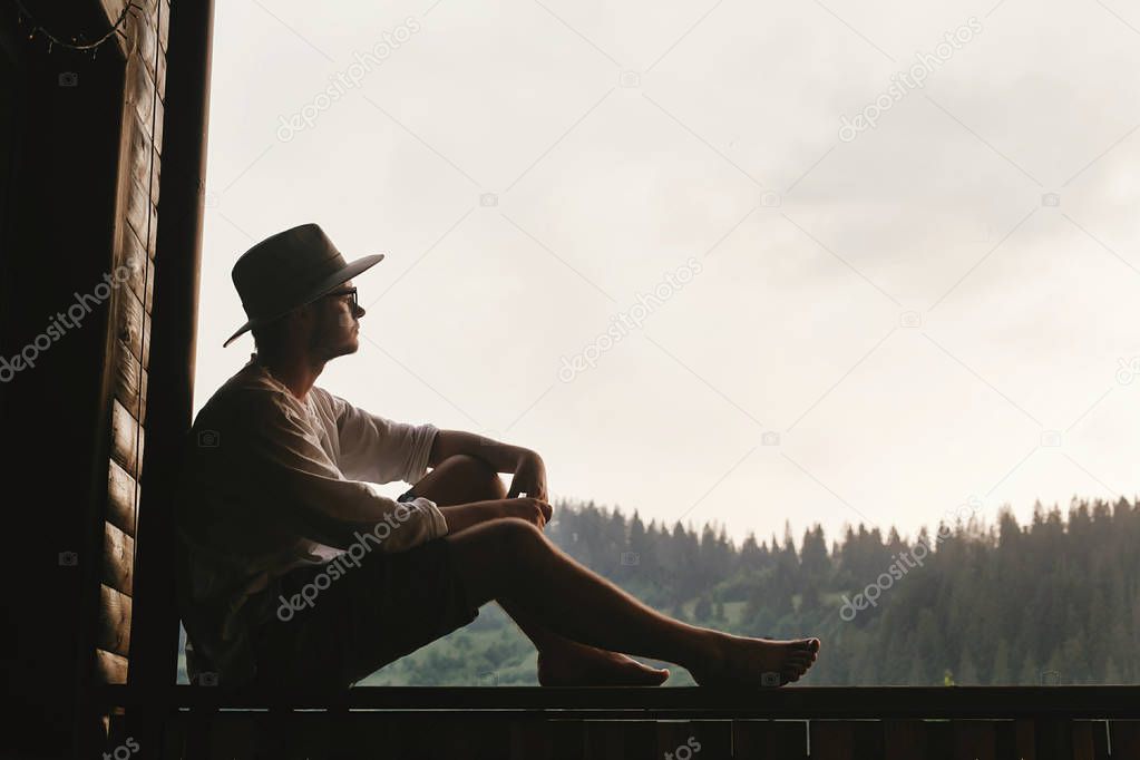 hipster man sitting on porch