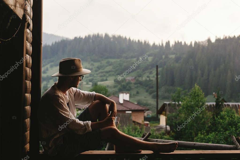 hipster man sitting on porch
