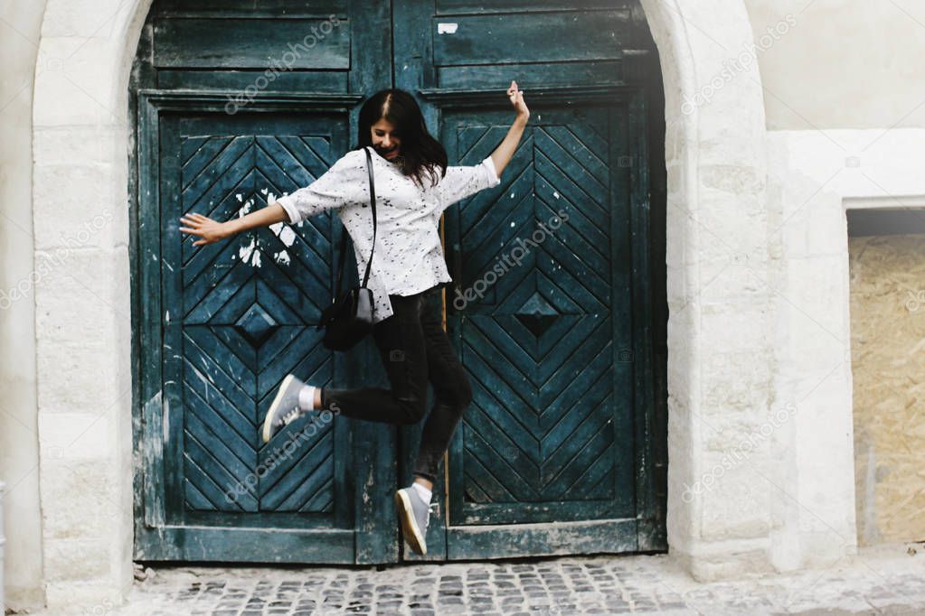 happy stylish hipster woman jumping 