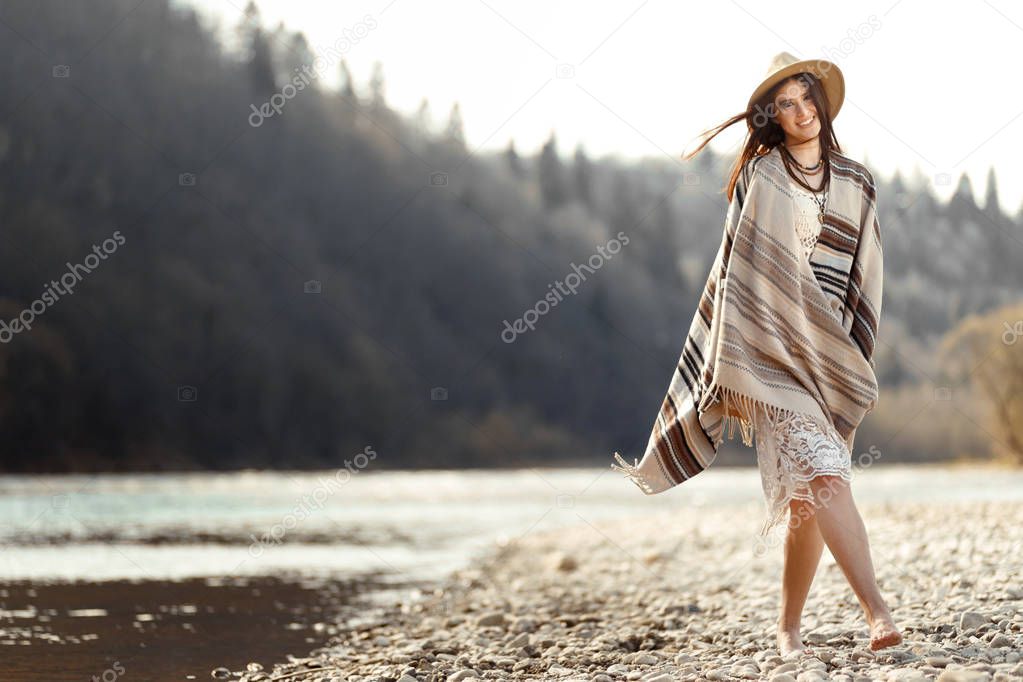 woman hipster walking on river beach