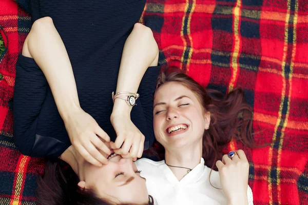 Girls lying on blanket in park Stock Image