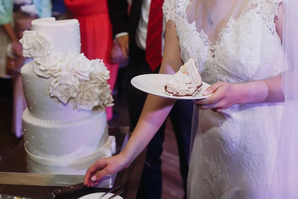 Невеста держит кусок торта — стоковое фото