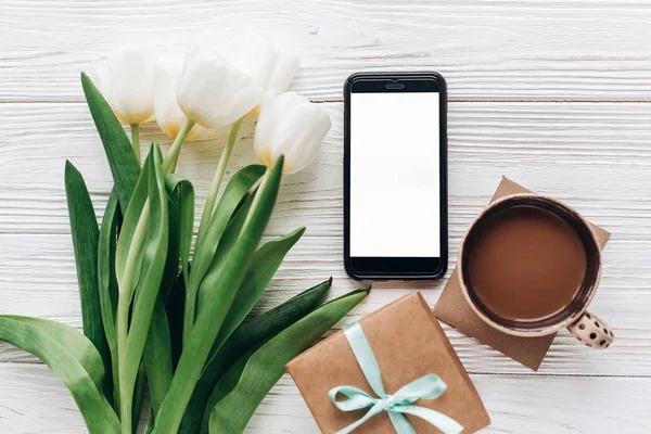Phone, tulips, gift box and coffee — Stock Photo, Image