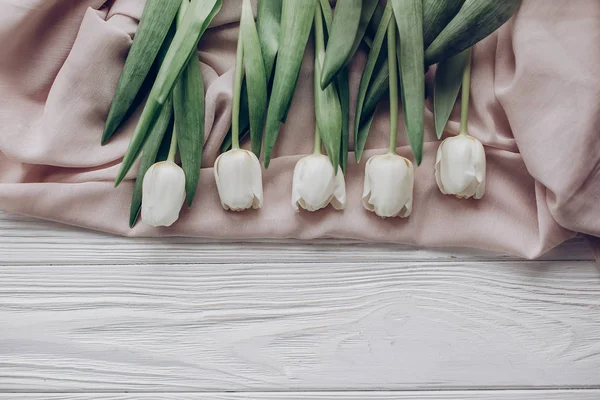 White tulips and beige soft fabric — Stock Photo, Image