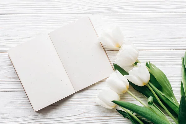 Craft notebook, pen and white tulips — Stock Photo, Image