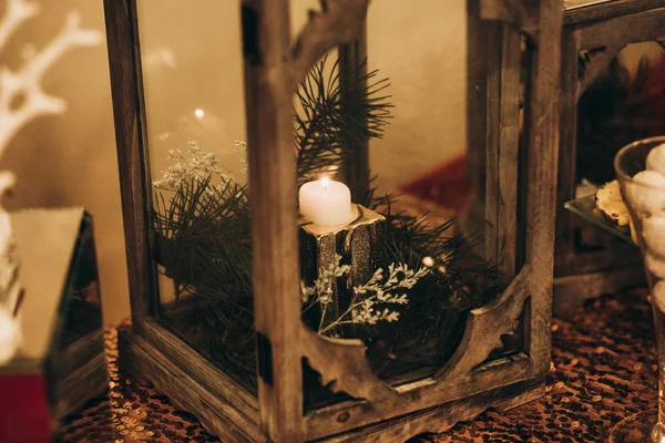 Burning candle in wooden lantern — Stock Photo, Image
