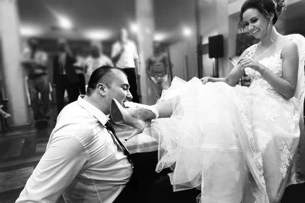 Groom taking off garter of  bride — Stock Photo, Image