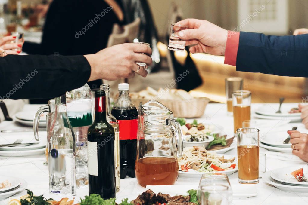 guests toasting drinks in glasses