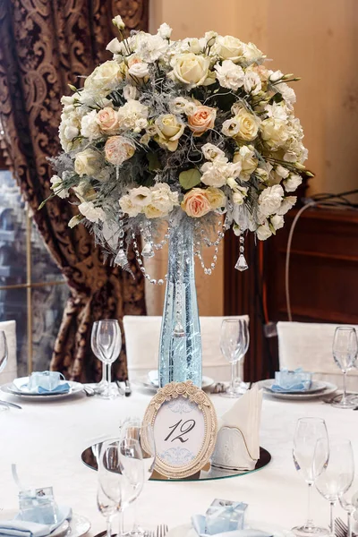 Wedding decor with flowers and glass vase — Stock Photo, Image